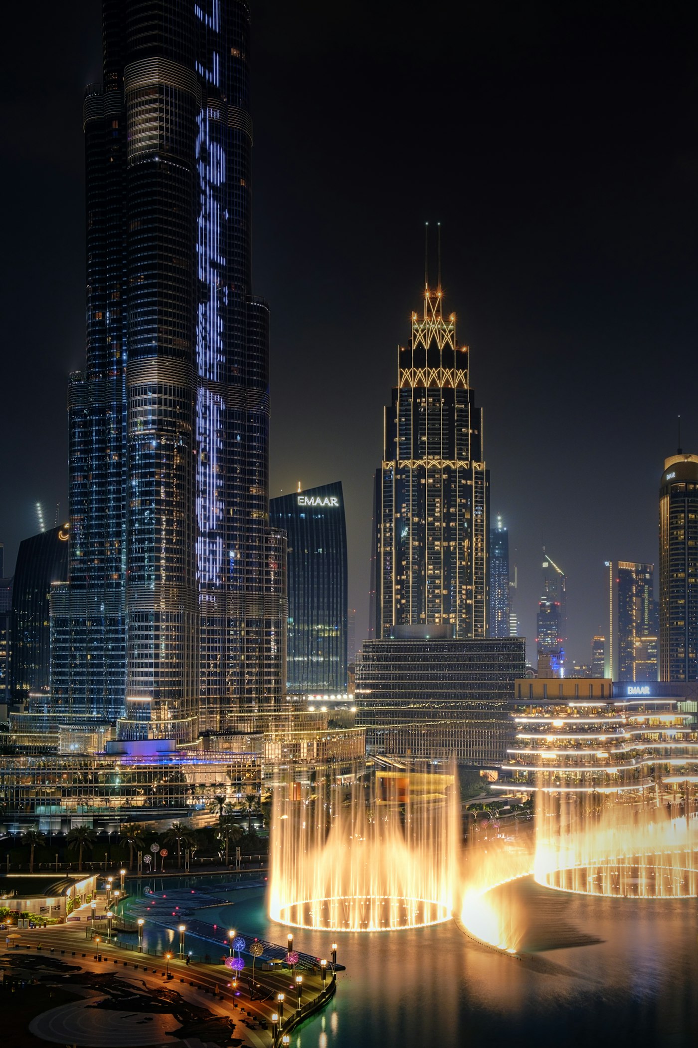 The Dubai Fountain performing at night beside Burj Khalifa